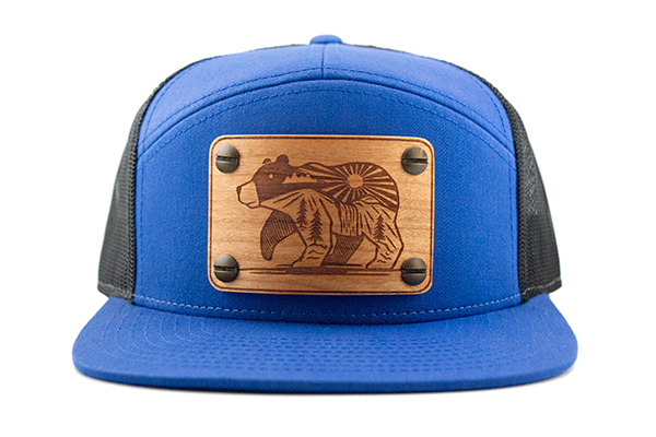 Blue 7-panel cap with cherry wood patch.